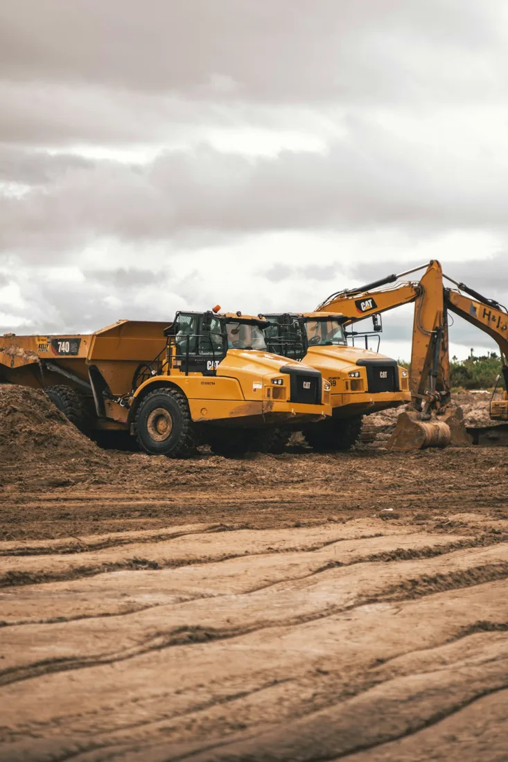 Earthmoving equipment on a broad dirt site